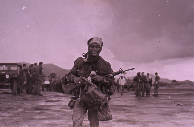 The Montagnard tribesman named Koch is all smiles moments after exiting the last Marine Corps heavy-lift CH-53D Sea Stallion Sikorsky helicopter that returned from Laos after Operation Tailwind ended on Sept. 14, 1970. SF Medic Mike Rose was in the process of training Koch in fundamental medic skills before and during the top secret mission deep into Laos. He was one of the 49 men from B Company CCC were wounded during the mission. Of the 136 men who left Kontum on Sept. 11, 1970 for Operation Tailwind, three Montagnard team members were killed in action, three were wounded enroute to the target. (Photo courtesy of Gene McCarley._