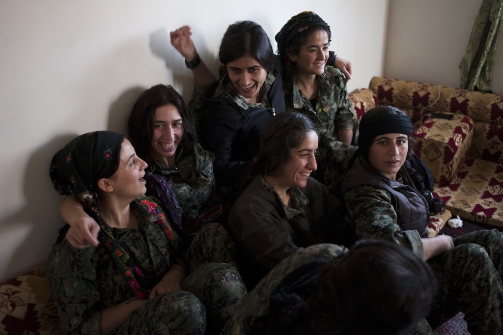 YPJ women celebrate together when two of their members return from the front lines to their base Tel Cochar in Rojava, Syria, November 20, 2014. All the women are a part of an elite sniper unit, whose efforts have been instrumental in driving back ISIS.