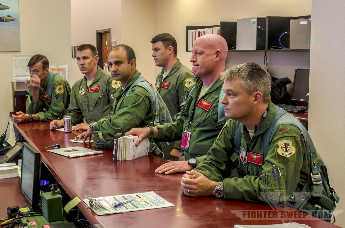 64th Aggressor Squadron briefing fighter jet mission