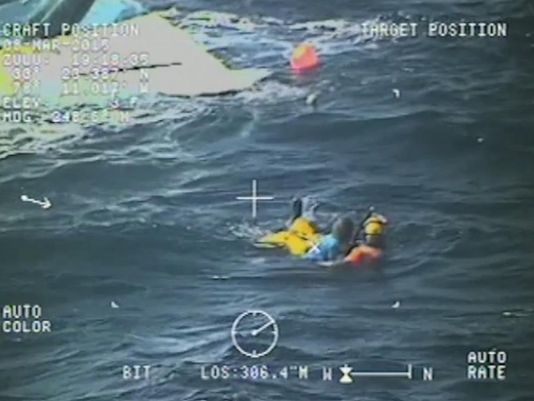 The USCG rescues two boaters after their vessel capsized off the North Carolina coast