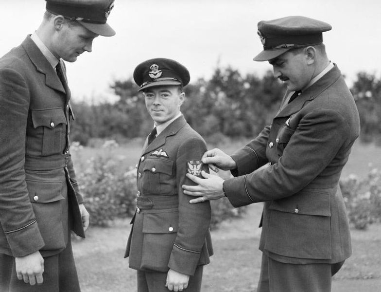 Three American pilots of No. 71 Eagle Squadron, RAF Pilot Officers Mamedoff. C "Shorty" Keough and G Tobin show off their new squadron badge at Church Fenton Yorkshire in October of 1940.