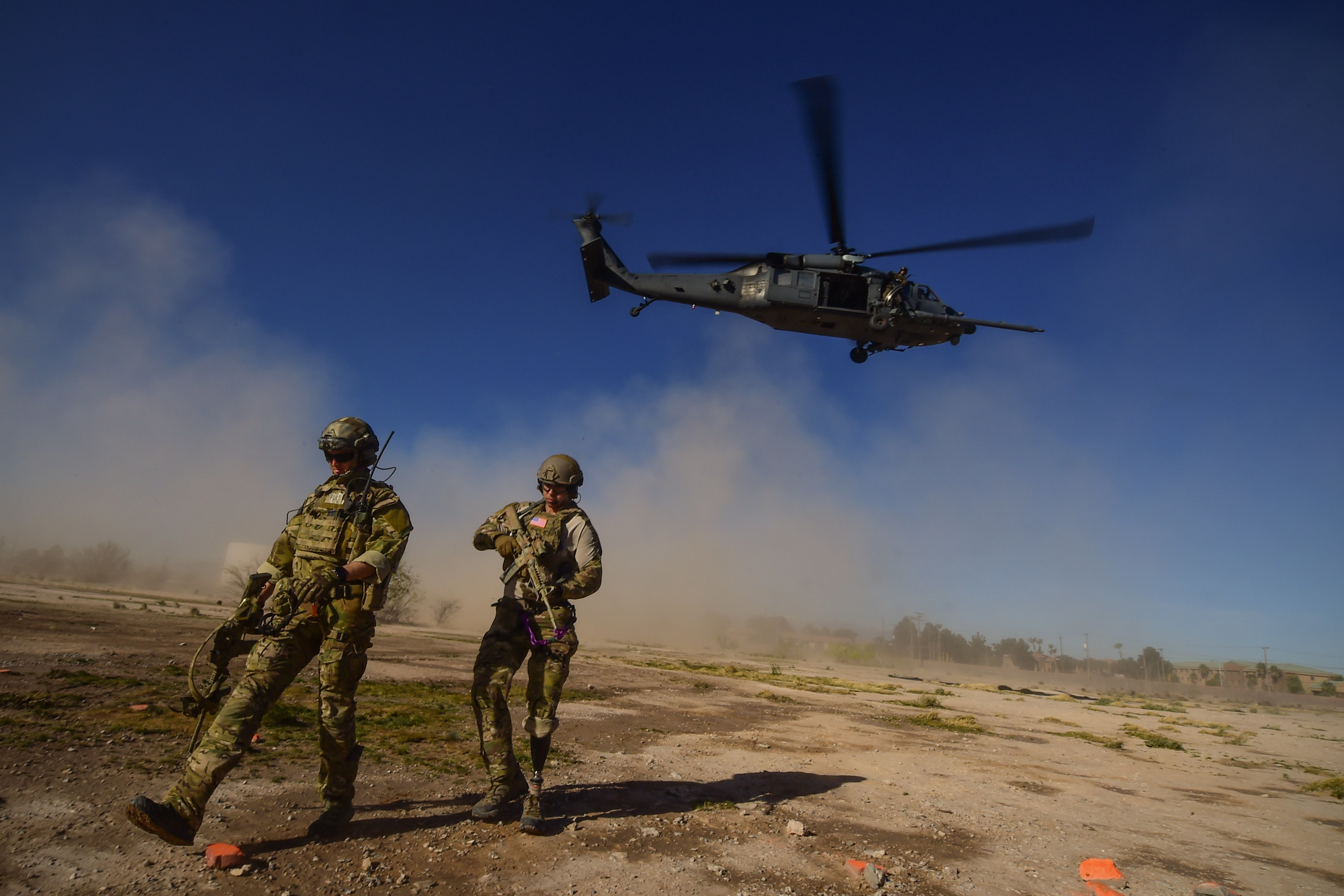 Staff Sgt. August O’Neil, Air Force Wounded Warrior, and fellow pararescueman and Wounded Warrior, Staff Sgt. Nick Robillard, prepare to deliver the Care Beyond Duty flag during the opening ceremony of the 2016 U.S. Air Force Trials at Nellis Air Force Base, Nev., Feb. 26, 2016. The Air Force Trials are an adaptive sports event designed to promote the mental and physical well-being of seriously wounded, ill and injured military members and veterans. More than 100 wounded, ill or injured service men and women from around the country will compete for a spot on the 2016 Warrior Games Team which will represent the Air Force at the US Military Academy at West Point in June. (U.S. Air Force photo by Senior Airman Taylor Curry/Released)