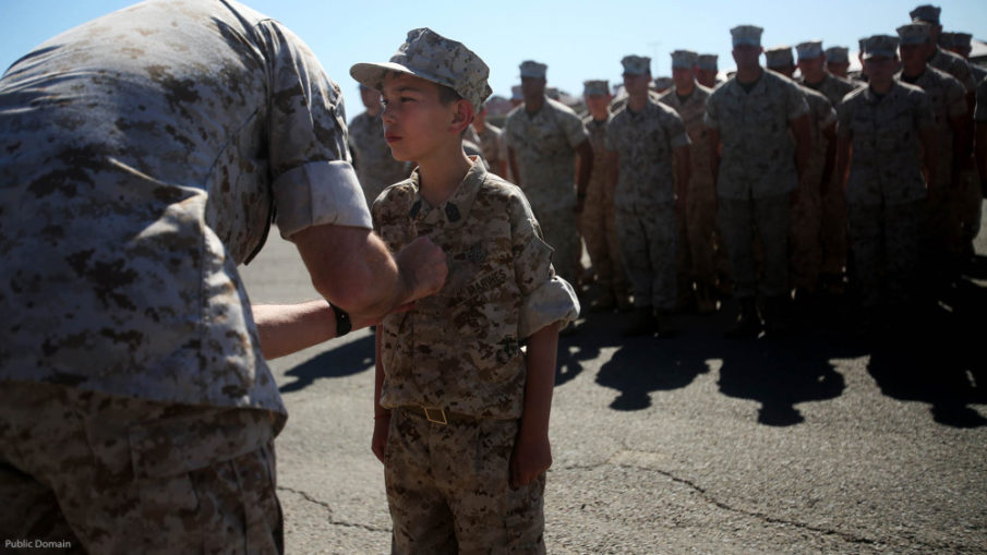 Nathan Aldaco, a 12 year-old boy with hypoplastic left heart syndrome, stands at attention as Col. Jaime O. Collazo pins on the Master EOD badge during a Make-A-Wish event supported by 7th Engineer Support Battalion, 1st Marine Logistics Group, aboard Camp Pendleton, Calif., March 24, 2016. Collazo is the 1st MLG chief of staff. Marines with 7th ESB and Explosive Ordnance Disposal helped to make Nathan’s wish of becoming a Marine come true by demonstrating the capabilities of their EOD robots and detonating TNT, C4, dynamite and blasting caps, while the heavy equipment operators gave him the opportunity to ride the D7 dozer and the excavator, in which he dug a pit, built a berm, and broke several large tree trunks. (U.S. Marine Corps photo by Sgt. Laura Gauna/released)