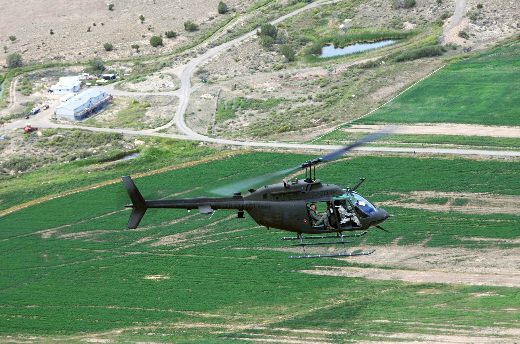 Members of the Colorado Counterdrug Task Force and Bureau of Land Management law enforcement officers fly over Montrose, Colo., in an OH-58 Kiowa helicopter in search of illegal marijuana grows on public lands in Colorado. Members of the Colorado Counterdrug Task Force assisted law enforcement officers from BLM with aerial surveillance over Colorado in August and September.