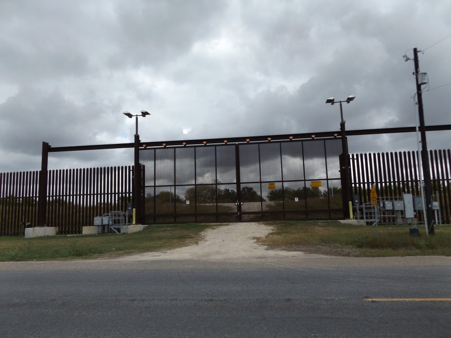 The border fence near Brownsville, Texas. The gate acts in respect to hydrological concerns and its inland offset allows for farm and ranchland access. 