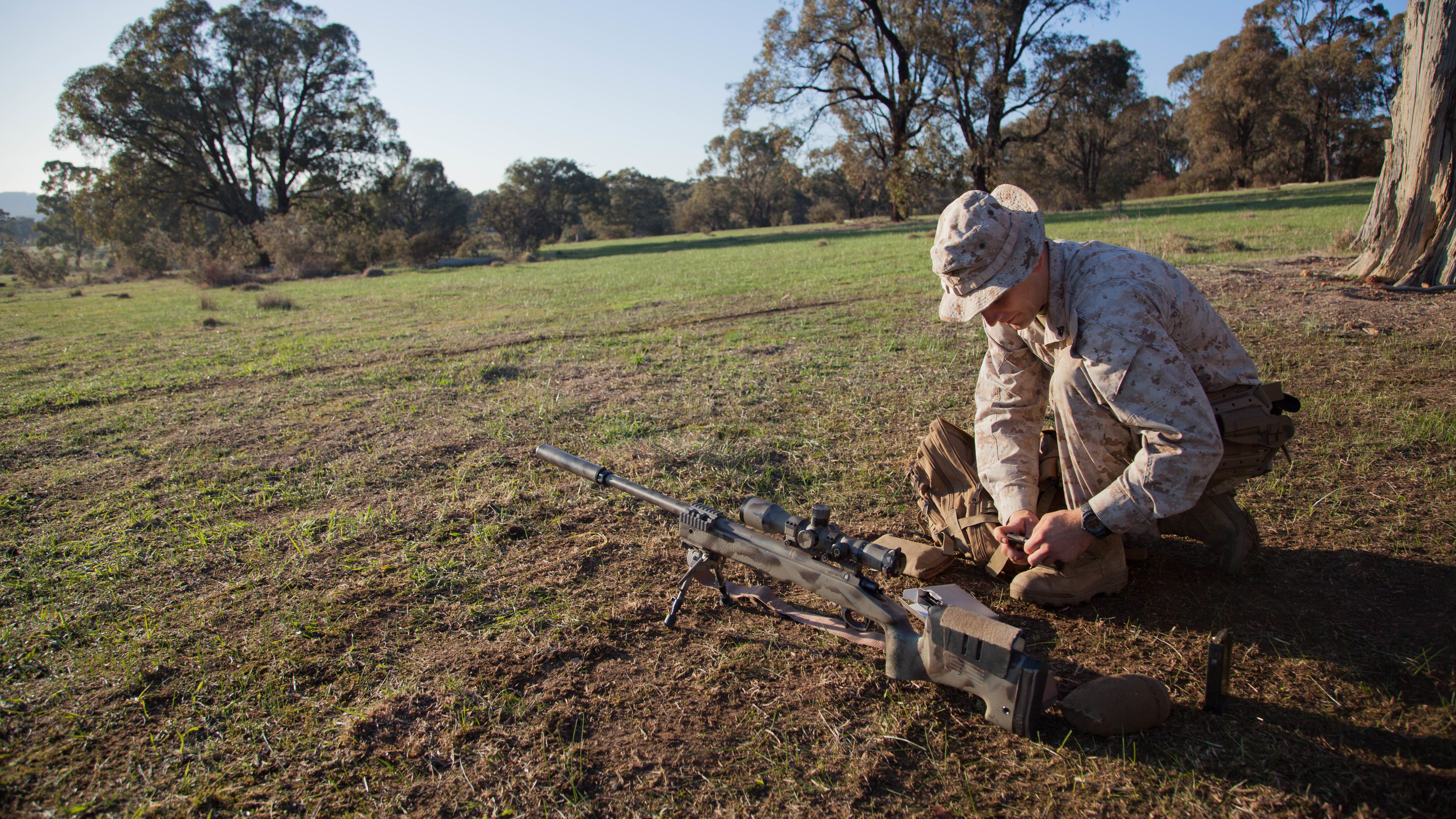 Cpl. John Luze, a competitor with the Marine Corps Shooting Team, loads a magazine before a practice fire with his M40A5 sniper rifle at Puckpunyal Military Area in Victoria, Australia, May 7, 2016. The M40A5 is a bolt-action sniper rifle that the Marine Corps uses for long-range enemy engagements.