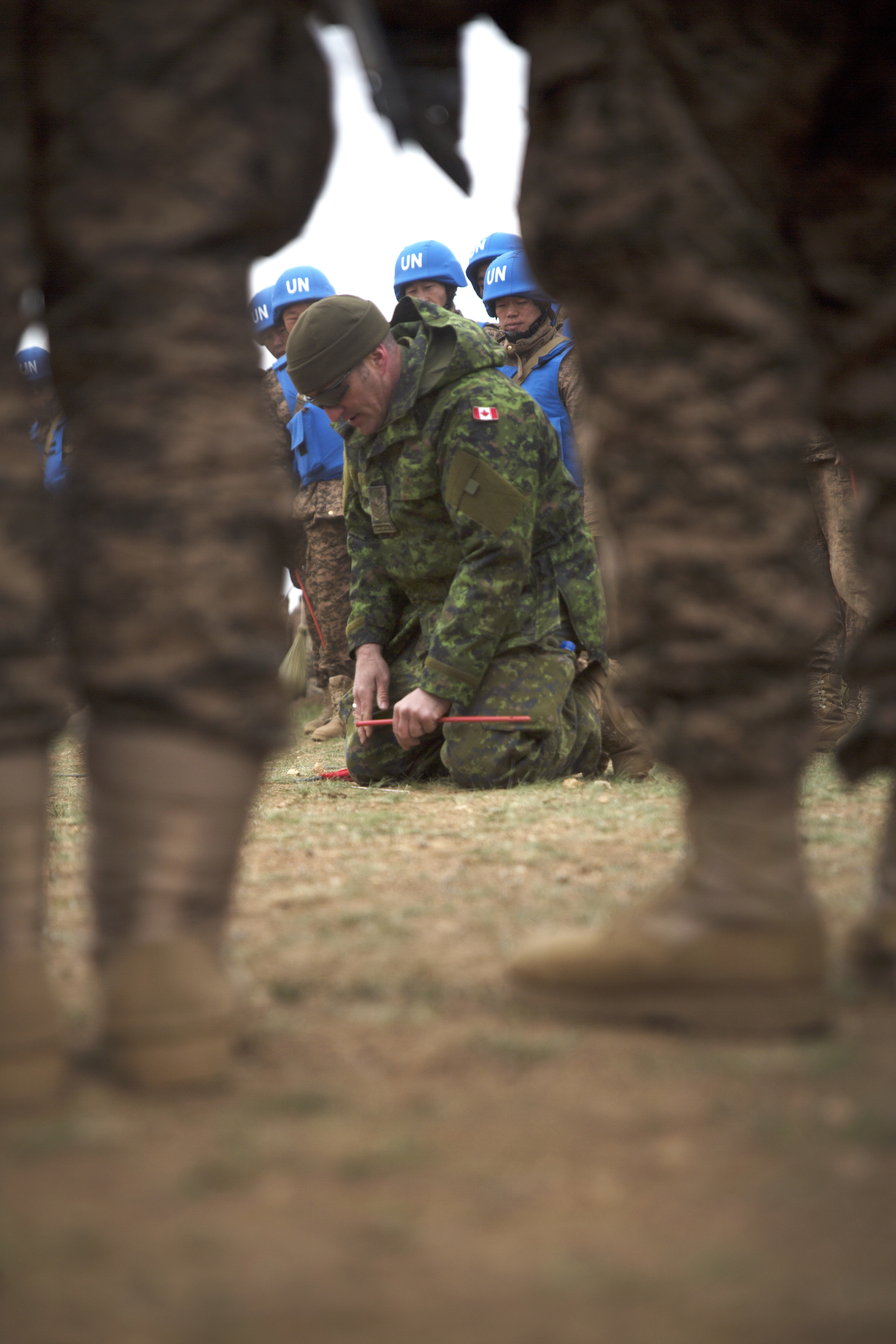 A member of the Canadian Army explains proper mine identification procedures to members of the Mongolian Armed Forces May 25 during the minefield self-extraction training portion of Khaan Quest 2016 at Five Hills Training Area near Ulaanbaatar, Mongolia. The training provided MAF members with the skills to safely identify and mark potential threats in a minefield. Khaan Quest 2016 is an annual, multinational peacekeeping operations exercise hosted by the Mongolian Armed Forces, co-sponsored by U.S. Pacific Command, and supported by U.S. Army Pacific and U.S. Marine Corps Forces, Pacific. Khaan Quest, in its 14th iteration, is the capstone exercise for this year’s Global Peace Operations Initiative program. The exercise focuses on training activities to enhance international interoperability, develop peacekeeping capabilities, build to mil-to-mil relationships, and enhance military readiness. (U.S. Marine Corps Photo by Cpl. Janessa K. Pon)