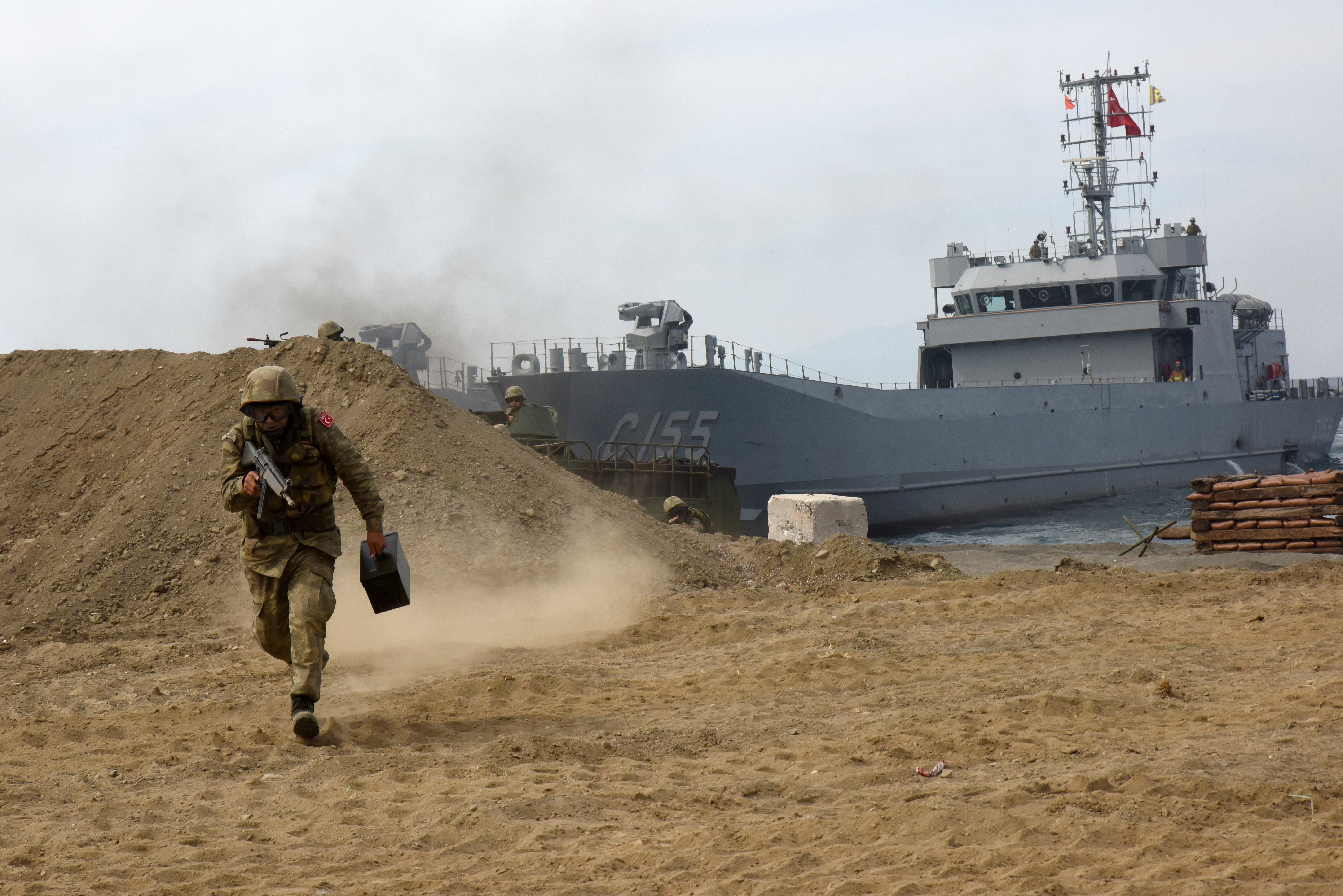 A soldier runs toward cover during a combined Air and Amphibious Assault. - DVIDS