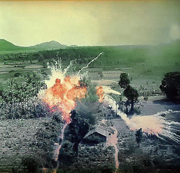 Napalm bombs explode on Viet Cong structures south of Saigon in the Republic of Vietnam. Image courtesy of National Archives and Records Administration.