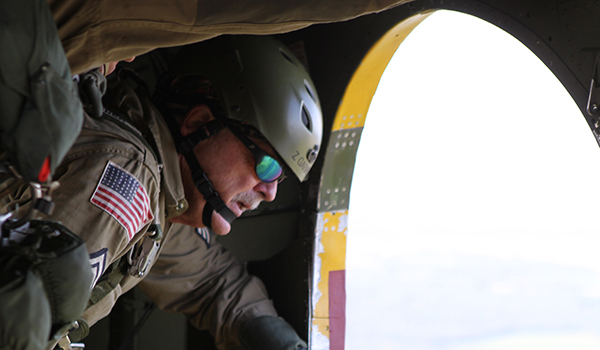 Retired U.S. Army Sgt. Butch Garner, primary jump master of the Liberty Jump Team, out of Fort Worth, Texas, prepares to throw out streamers out the side of a Douglas-DC3-C47, with fellow re-enactors for the Sustained Airborne Training in preparation for the 75th Anniversary Airborne School jump at McCarthy Hall in Fort Benning, Ga., Aug. 14, 2015. The 1-507th Parachute Infantry Regiment(PIR) Battalion celebrates 75 years of the U.S. Army Airborne School and the commemoration of the last qualifying jump of the first airborne test platoon on Aug. 15, 1940. (Photo by U.S. Army Sgt. McTaggart, Phillip Jacob/Released)