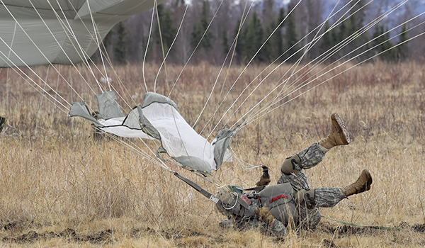 A paratrooper assigned to the 4th Brigade Combat Team (Airborne), 25th Infantry Division, U.S. Army Alaska, lands after jumping from a U.S. Air Force C-17 Globemaster III during a practice forced-entry parachute assault on Malemute drop zone at Joint Base Elmendorf-Richardson, Alaska, April 5, 2016. Having just successfully completed a rigorous evaluation at the Joint Readiness Training Center, the 4th Brigade Combat Team (Airborne), 25th Infantry Division is currently the most highly trained brigade combat team in the U.S. Army and is prepared to deploy globally at a moment's notice to execute combat, humanitarian assistance and/or disaster relief operations. (U.S. Air Force photo/Alejandro Pena)
