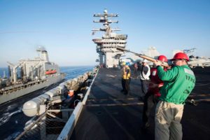 Chief Aviation Electronics Technician Chris Logan fires a shotline to the fleet replenishment oiler USNS Bighorn (T-AO 198) on the flight deck of the aircraft carrier USS Dwight D. Eisenhower (CVN 69) (U.S. Navy photo by Mass Communication Specialist Seaman Apprentice Neo Greene III/Released)