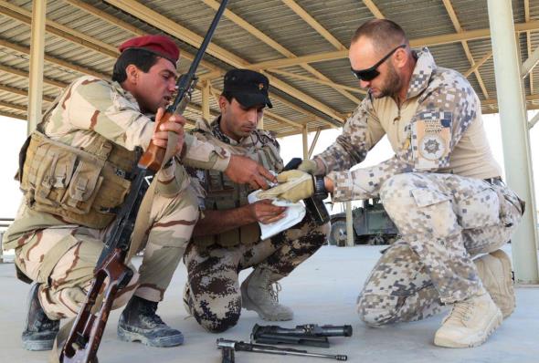 Latvian soldier trains Iraqi soldiers on SVD Dragunov sniper rifle.