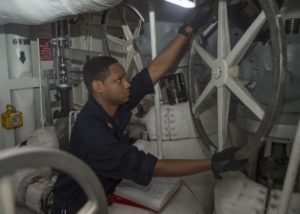 Engineman 2nd Class Cory Winston adjusts steam configurations in the catapult number two piping space of the aircraft carrier USS Dwight D. Eisenhower (CVN 69) (U.S. Navy photo by Mass Communication Specialist Seaman Apprentice Joshua Murray)