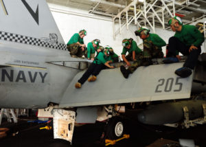 Sailors assigned to the Checkmates of Strike Fighter Squadron (VFA) 211 perform corrosion prevention maintenance on an F/A-18F Super Hornet (US Navy photo-Mass Communication Specialist 3rd Class Jared King)