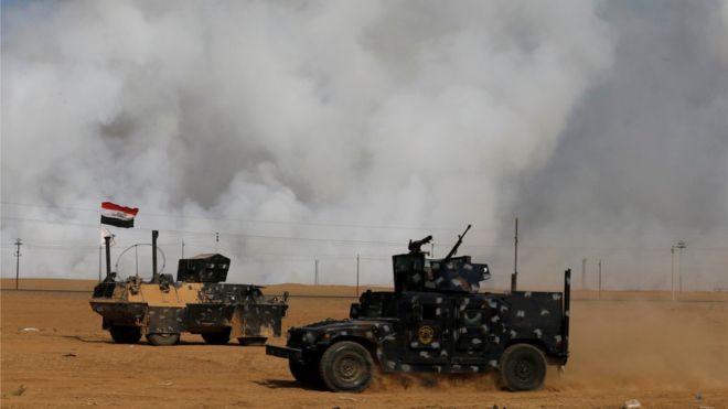 US Troops mask up against toxic fumes in Iraq