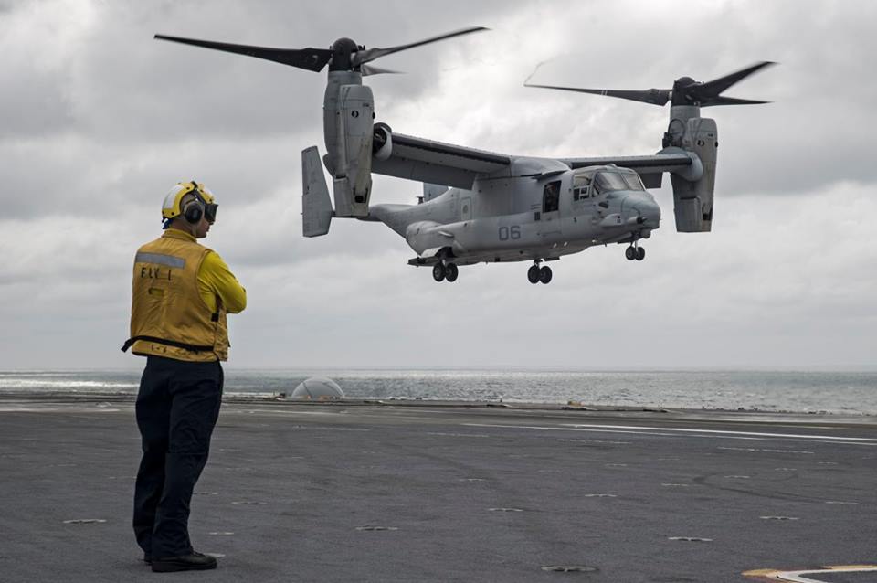 Petty Officer 2nd Class Brandon McCallum, from White Cloud, Mich., observes as an MV-22B Osprey transport aircraft assigned to the Blue Knights of Marine Medium Tiltrotor Squadron (VMM) 365 prepares to land on the flight deck of the aircraft carrier USS George Washington (CVN 73). George Washington, homeported in Norfolk, is underway in the Atlantic Ocean. (U.S. Navy photo by Petty Officer 3rd Class Bryan Mai) 