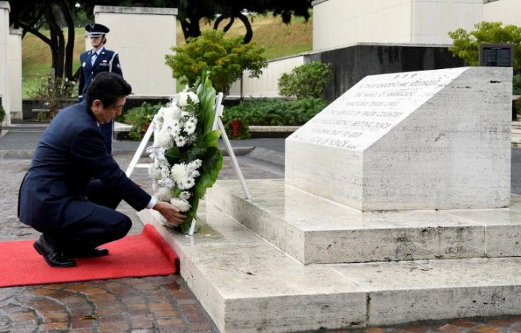 Japan’s Abe pays respects at Hawaii memorials on eve of Pearl Harbor trip