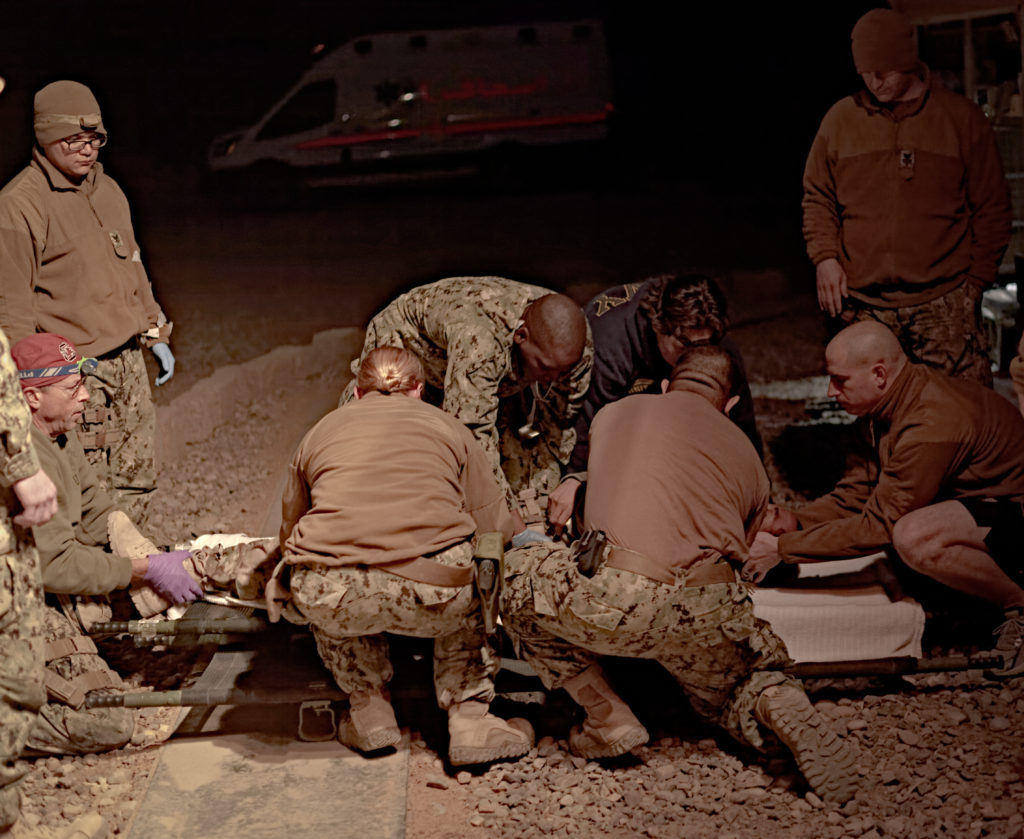 Navy Role II personnel accept patient