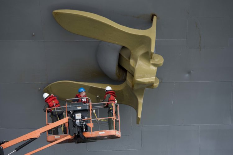 Photo of the Day: CO of USS Dwight D. Eisenhower (CVN 69) Painting Ships Anchor Gold