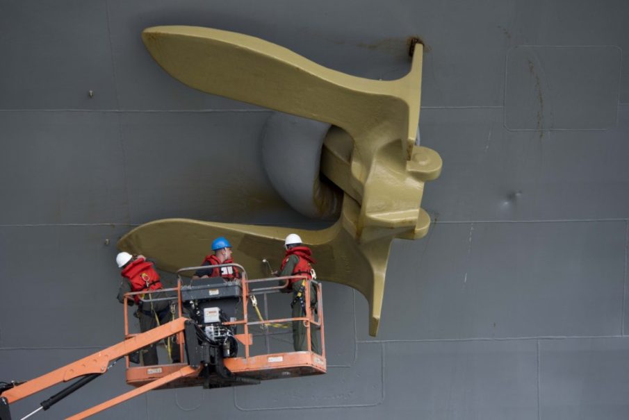 Photo of the Day: CO of USS Dwight D. Eisenhower (CVN 69) Painting Ships Anchor Gold