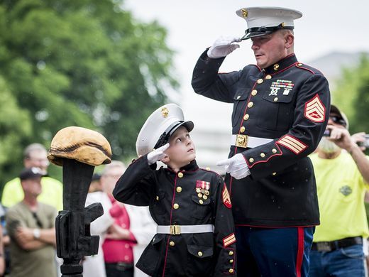 Former United States Marine Tim Chambers gives instructions to Christian Jacobs