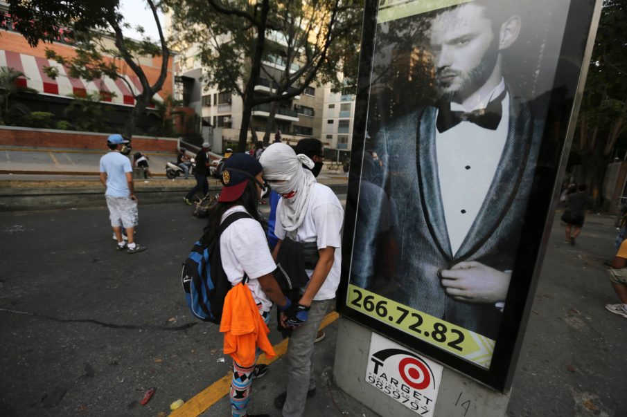 Fugitive Venezuela police pilot pops up at opposition vigil