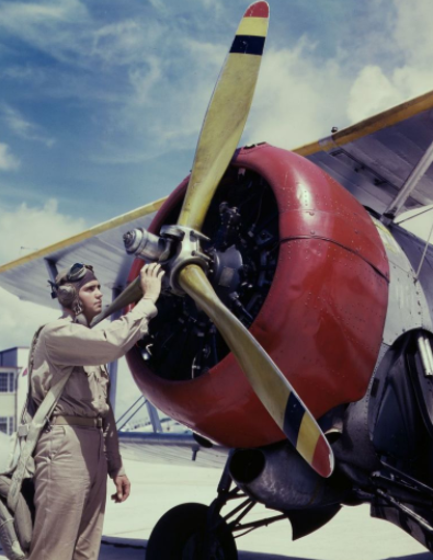 Aviation_Cadet_Thanas_inspects_an_airplane_engine