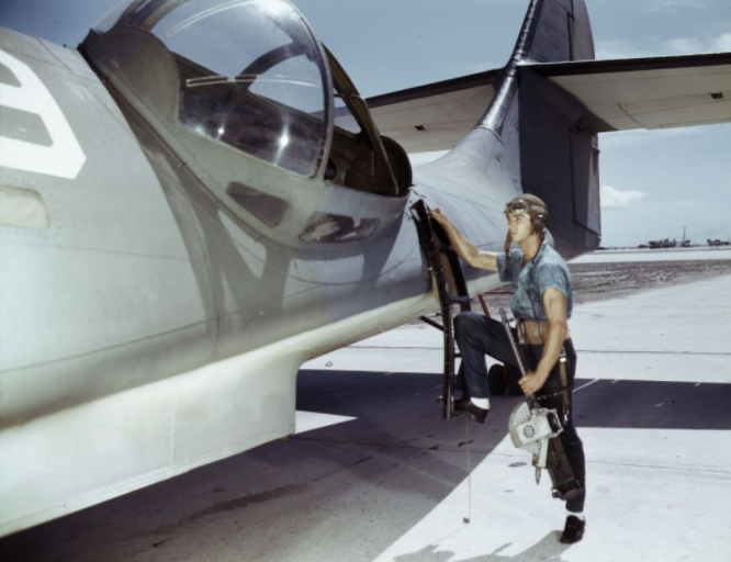 Aviation_Ordnance_Mate_Jesse_Rhodes_Waller_prepares_to_install_30-caliber_machine_gun_in_a_Navy_PBY_plane