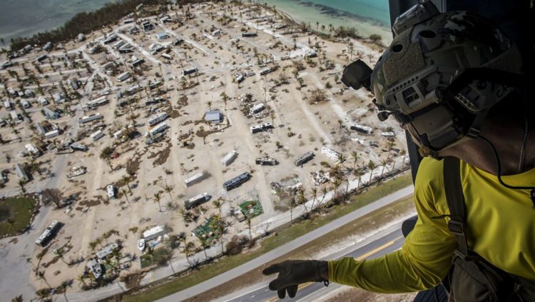 Picture of the Day: Air Force Pararescueman Aboard HH-60G Pave Hawk Surveys Damage by Hurricane Irma