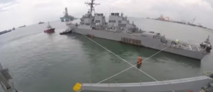 Watch: Damaged USS John S. McCain loaded onto heavy transport ship for repairs