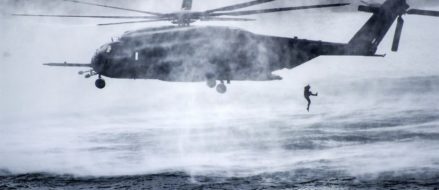 Service member jumps from Navy MH-53E Sea Dragon Helicopter