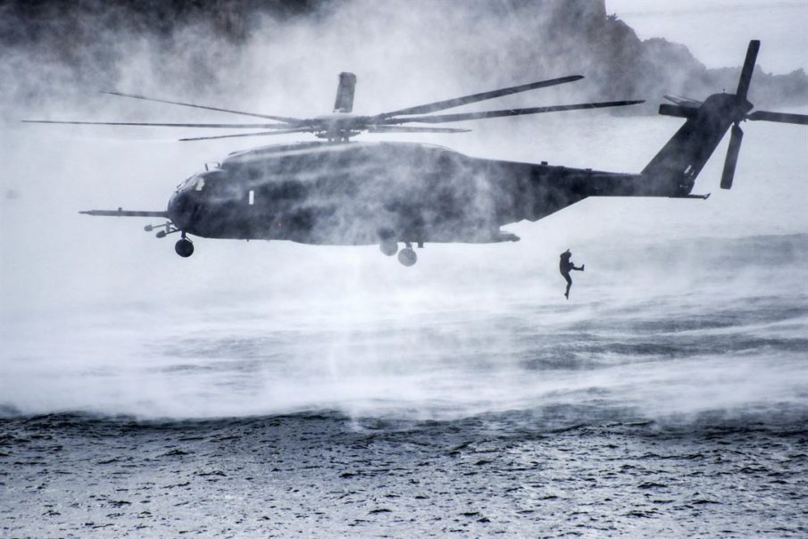Service member jumps from Navy MH-53E Sea Dragon Helicopter