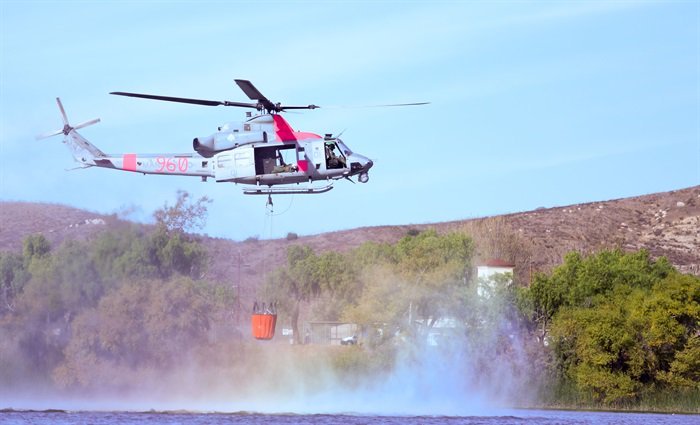 UH-1Y Venom from Marine Light Attack Helicopter Squadron (HMLA) 267 grabs load of water from Lake O’Neil