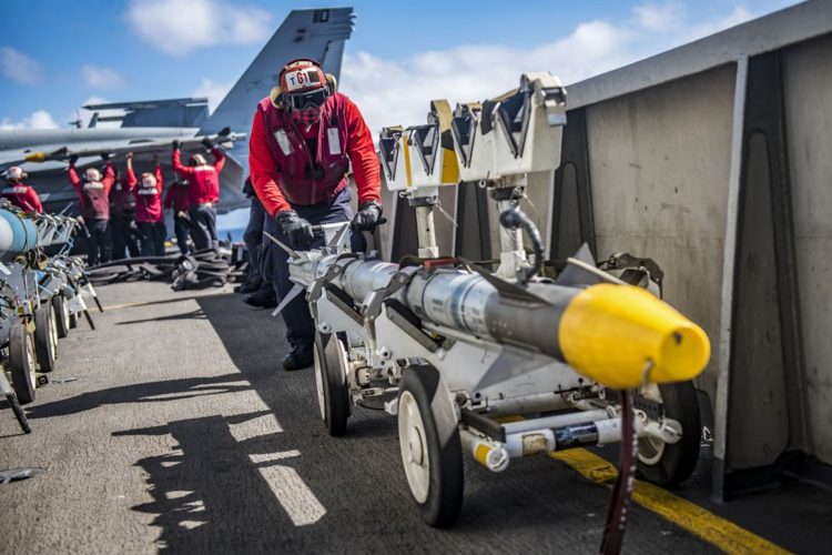 Picture of the Day: Seaman Charles Joseph Positions a Missile on the Flight Deck of the USS Carl Vinson