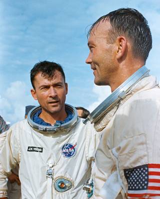 Gemini X astronauts John Young, left, and Mike Collins stand on the deck of USS Guadalcanal following splashdown and recovery on July 21, 1966.