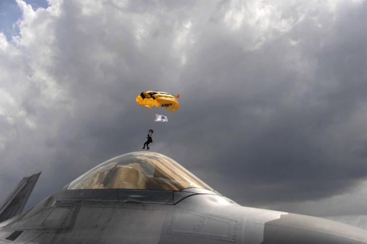 Picture of the Day: Army Golden Knights Drops in on an Air Force F-22 Raptor