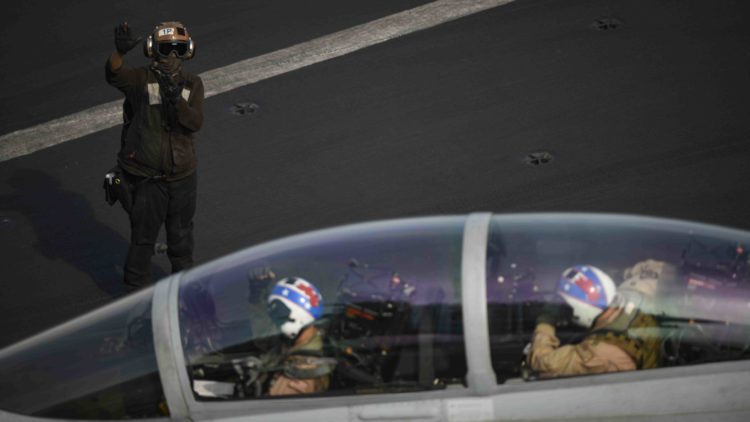 Picture of the Day: Plane Captain Signals Pilots on the USS Theodore Roosevelt