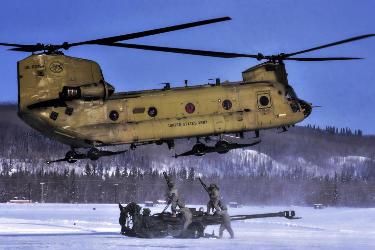 Picture of the Day: Soldiers Attach 155 mm Howitzer to a CH-47 Chinook Helicopter