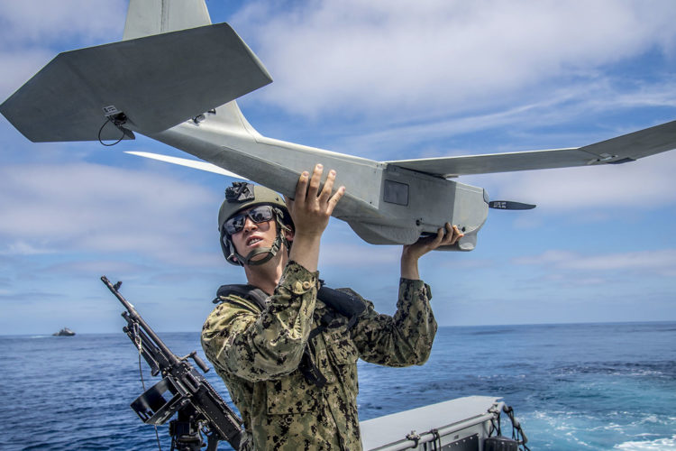 Picture of the Day: Petty Officer 3rd Class Neil Wierboski Launches a Drone from a Patrol Boat