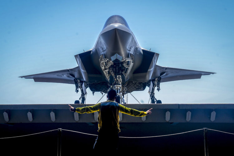 Picture of the Day: Navy Petty Officer 1st Class Glenn Catbagan Directs an F-35B Lightning II on the USS Essex
