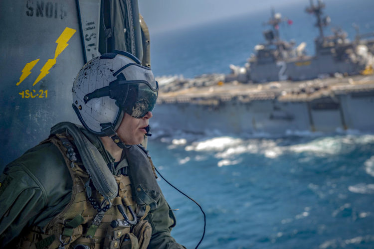 Picture of the Day: Navy Petty Officer 2nd Class Eric Smith in an MH-60S Seahawk Helicopter