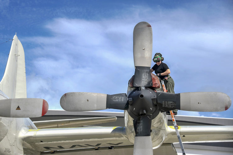 Picture of the Day: Navy Petty Officer 2nd Class Melissa Ellis Fastens a Propeller on a P-3C Orion