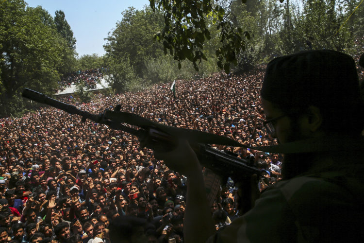 The Pic of the Day: Kashmiri rebel fires his gun to salute fallen comrades