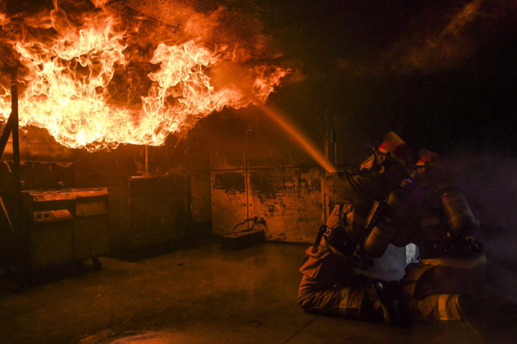 The Pic of the Day: Firefighters kneel to take on the blaze
