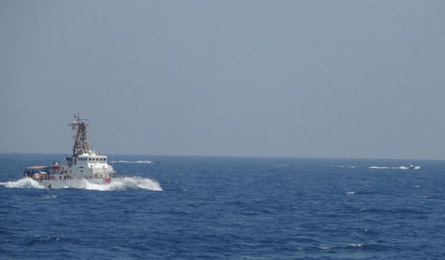 Two Iranian fast-attack boats approach the Coast Guard cutter Maui at high speed in the Strait of Hormuz on Monday.