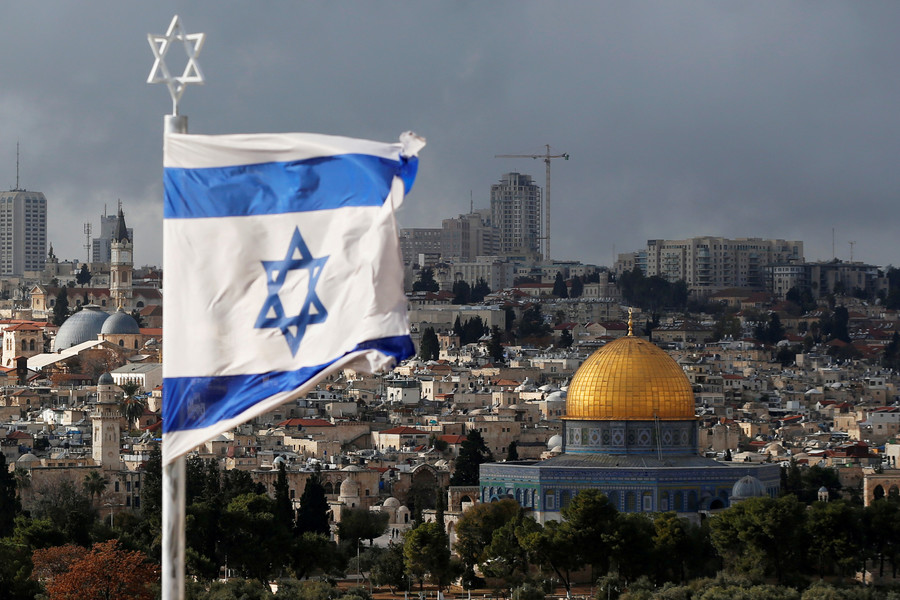 The Israeli flag flies over Jerusalem. The Dome of the Rock, the third holiest site in Islam is seen in the background.