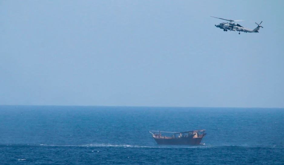 A Navy Seahawk helicopter approaches a dhow that was en route to Yemen carrying a cache of illegal weapons. (U.S. Navy)