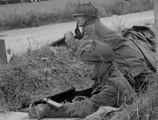 British soldiers fire a Sten gun during WWII.