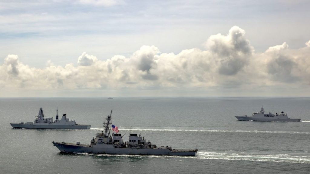 HMS Defender, USS Laboon, and Dutch frigate with a Russian ship in the distance monitoring the group last week in the Black Sea.